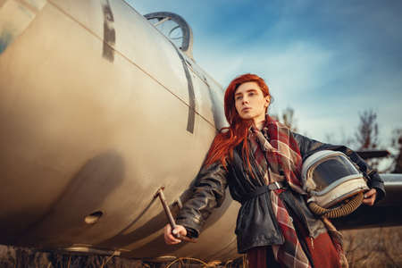 redhead girl in black leather jacket and helmetの写真素材