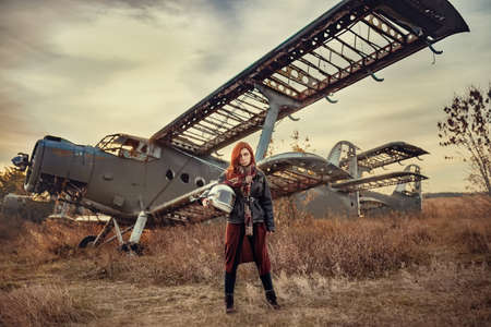 redhead girl in black leather jacket and helmet