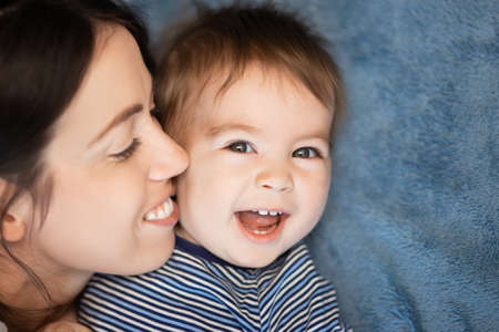 mother and baby boy on bedの写真素材