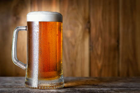 mug of beer on wooden tableの写真素材