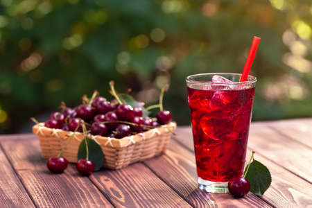 cherry juice or cocktail with ice in glassの写真素材