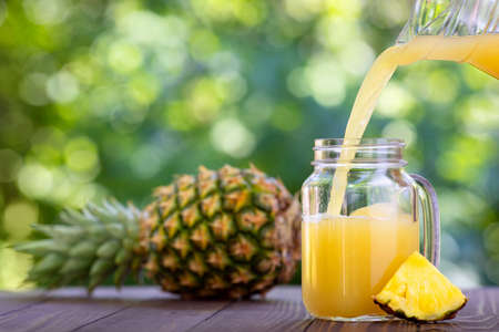 pineapple juice pouring in mason jarの写真素材