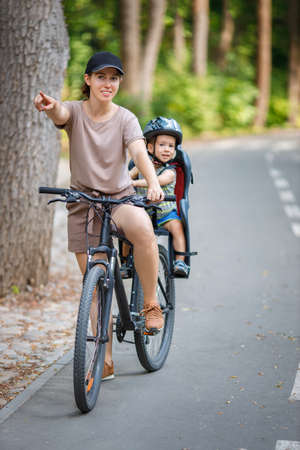 Mother with son riding on bikeの写真素材