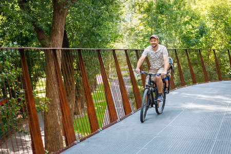 father with son riding on bike
