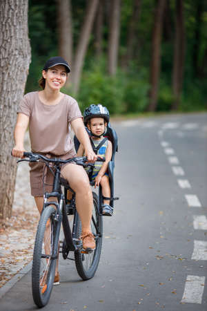 Mother with son riding on bikeの写真素材