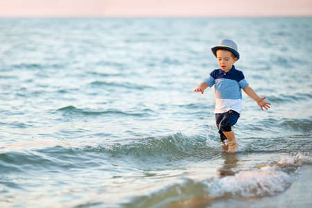 little boy running on the sea beachの写真素材