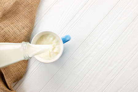 milk pouring into cup
