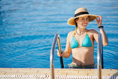 portrait of smiling woman in swimming pool