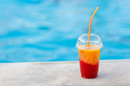 fresh mango with strawberry juice or smoothie near the poolの写真素材