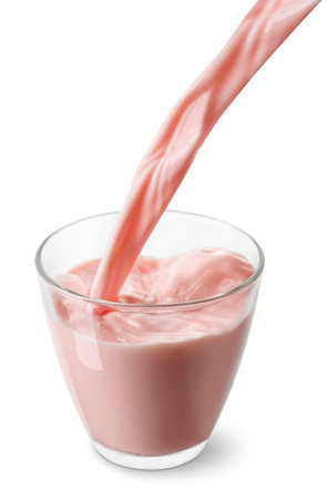 strawberry or cherry milk pouring into glass isolated on white backgroundの写真素材