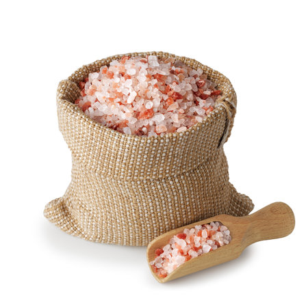 Himalayan salt in sack and scoop isolated on white backgroundの写真素材