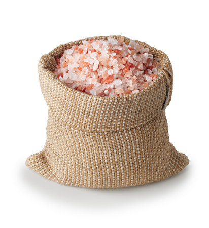Himalayan salt in burlap sack isolated on white background.の写真素材