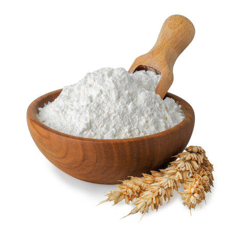 flour in wooden bowl and scoop inserted on top with ears of wheat near isolated on white backgroundの写真素材