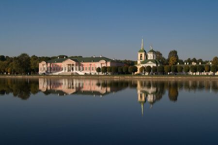 Old buildings near the lake with beautiful reflectionsの写真素材