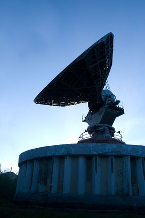 Old radar in the evening skyの写真素材