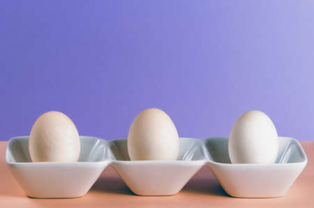 Three duck eggs in a white porcelain dishの写真素材