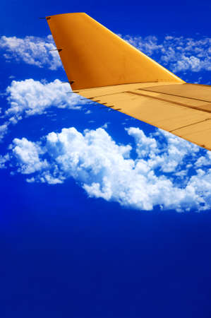 Flying in the high sky - Airplane wing and blue sky