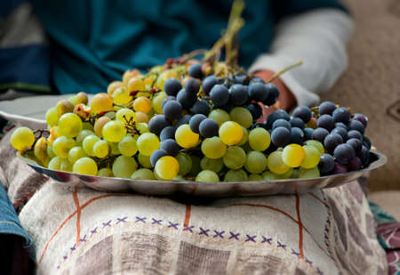 Plate of Grapes on the lapの写真素材