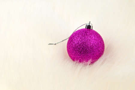Christmas decoration - Single bauble on top of furの写真素材