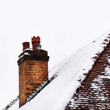 Chimney and foortop in snowy conditionsの写真素材