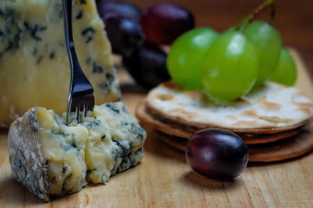 Roquefort blue cheese with grapes and crackersの写真素材