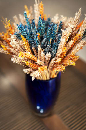 Colorful decorative vase with dried wheatの写真素材
