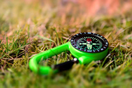 Compass on the grass close up outdoors conceptの写真素材