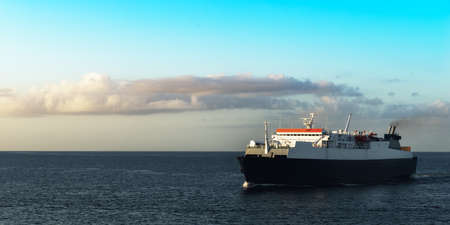 Ferry boat transporting passengers sailing sunrise in Trinidad and Tobagoの写真素材