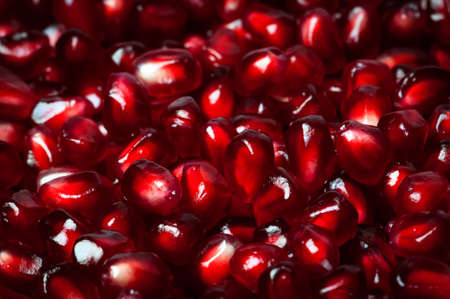 Delicious red ripe juicy pomegranate seed background texture macro closeupの写真素材