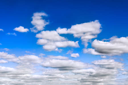 Blue sky and white clouds background spread across the frame