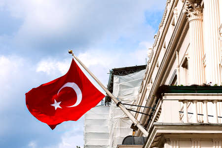 Turkish flag waving from the embassy balcony in London exterior view front entrance outdoorsの写真素材