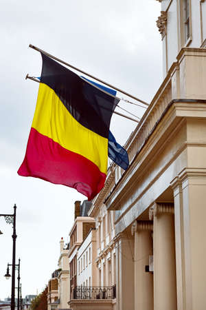Belgium and European Union flags waving from the embassy balcony in London exterior view front entranceの写真素材