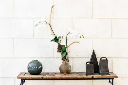 Interior decorative arrangement ornament with orchid bells and ceramic ballの写真素材