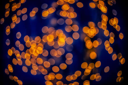 Bokeh background glowing oval shaped glow dark orange and blue emptyの写真素材