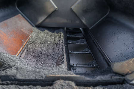 Close up of asphalt road paver paiving machine in construction industryの写真素材