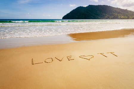 Word Love TT Trinidad and Tobago written on the beach sand in Maracas Bay Beachの写真素材