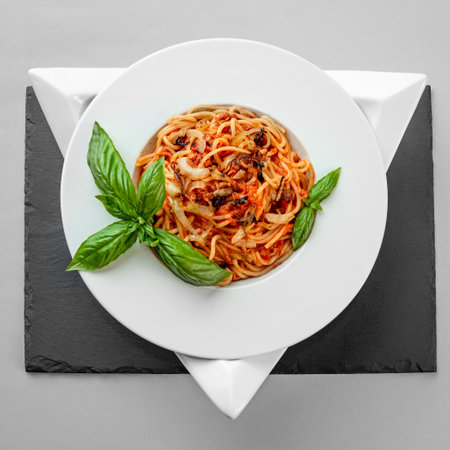 Spaghetti tuna pasta basil plate triangle shape slate table pretty appetizing gray background isolatedの写真素材