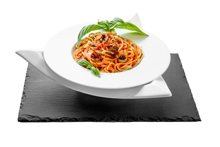 Spaghetti tuna pasta basil plate triangle shape slate table pretty appetizing white background isolatedの写真素材