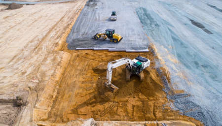 Aerial photo of trucks and bulldozers on construction site in Treillieres, France
