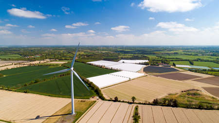 Aerial photo of a wind turbine in a fieldの写真素材