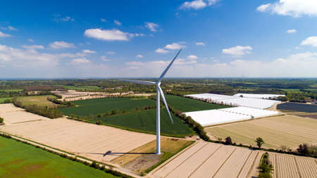 Aerial photo of a wind turbine in a fieldの写真素材