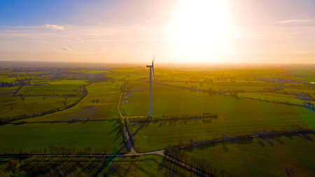 Aerial photo of a wind turbine in a fieldの写真素材