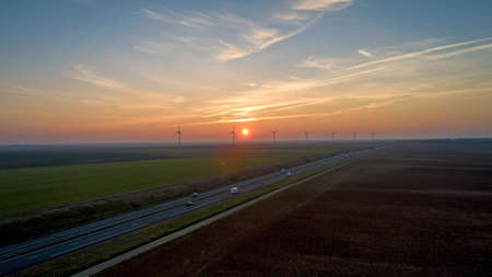 Wind turbines along the highway at sunset, Franceの写真素材