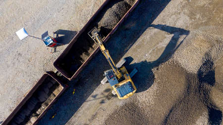 Aerial photo of an excavator loading a wagon with gravelのeditorial素材