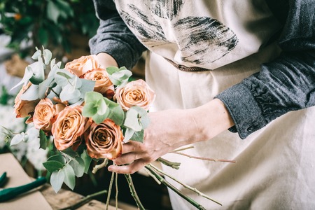 Flower arrangement in beautiful bouquet made by professional floristの写真素材