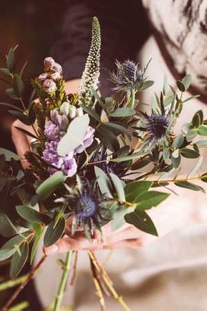 Florist working in modern flower shop. Young woman entrepreneur with her own business.の写真素材