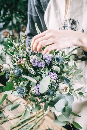 Florist working on the workspace in flower shop to create bouquetの写真素材