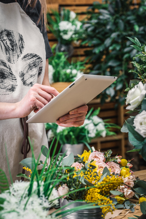 Florist working on a tablet in the shopの写真素材