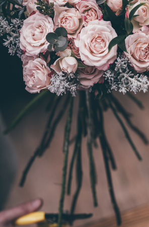Florist cuts a bouquet of beautiful flowersの写真素材