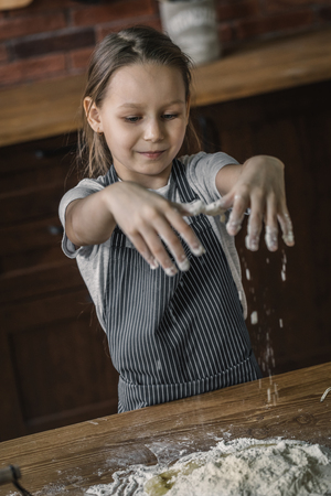 Little girl with hands in flour